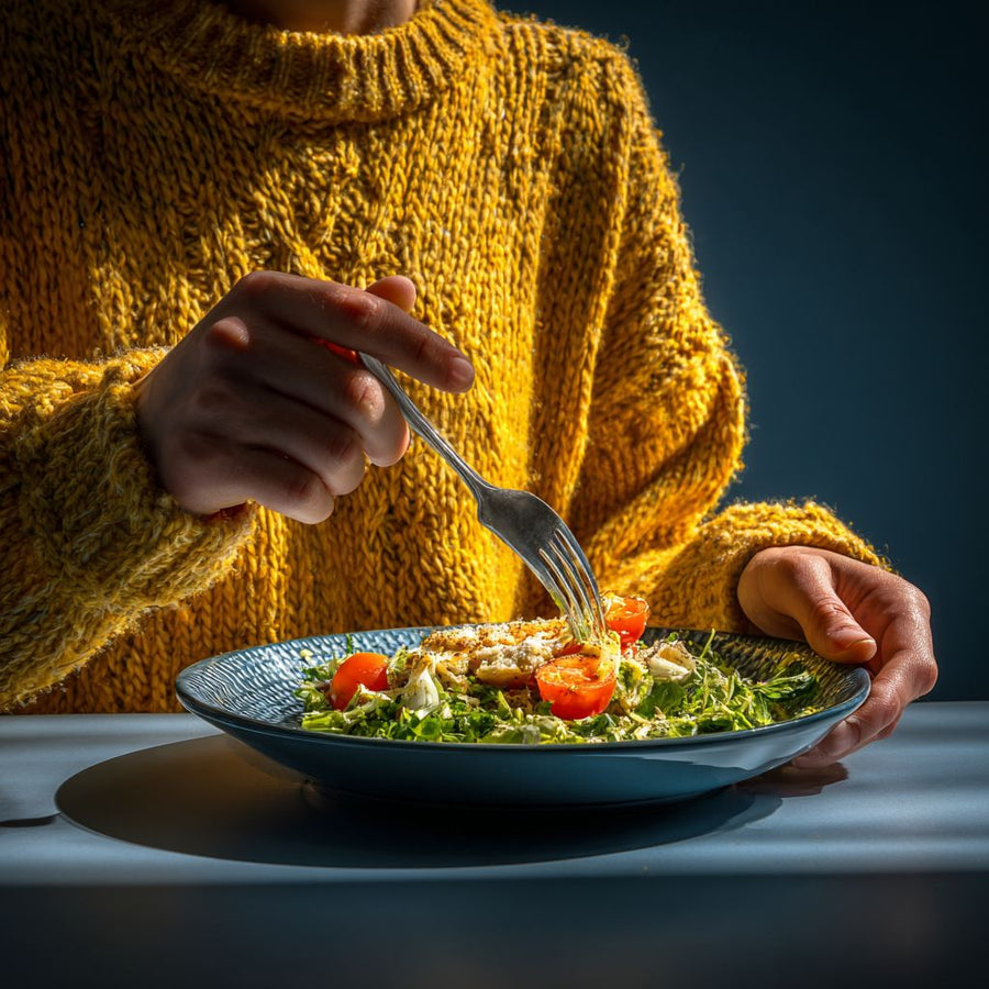 Person eating a keto-style salad lunch